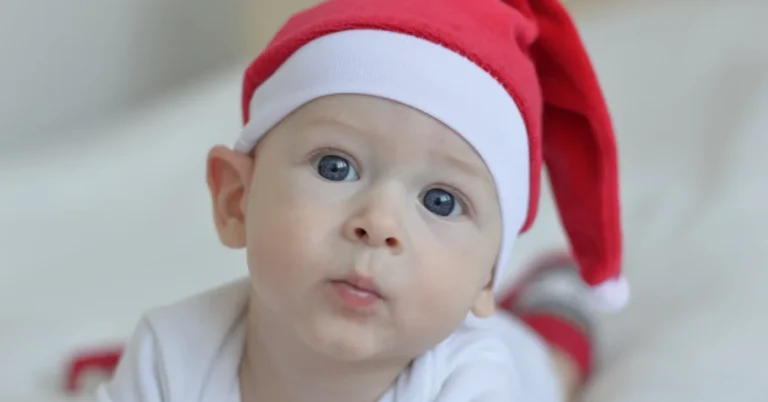 Baby Wearing Red Christmas Hat on White Textile